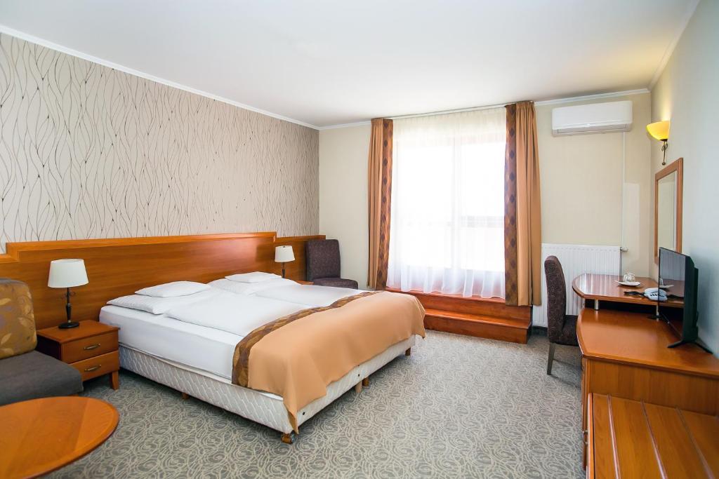 Postel nebo postele na pokoji v ubytování Hotel Narád