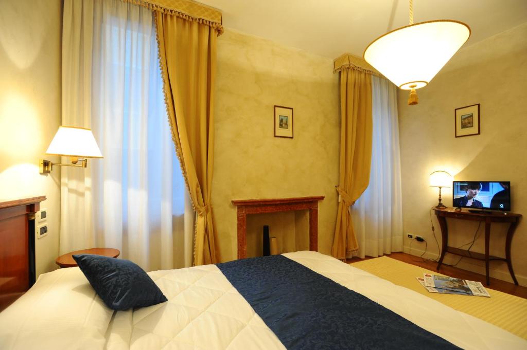a bedroom with a bed and a television in it at Locanda del Ghetto in Venice