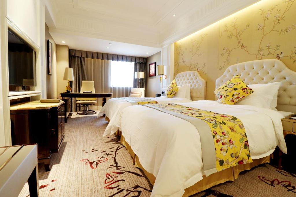 Postel nebo postele na pokoji v ubytování Estandon Hotel Guangzhou