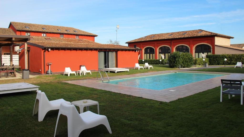 a house with a swimming pool in the yard at Corte Di Frara in Parma