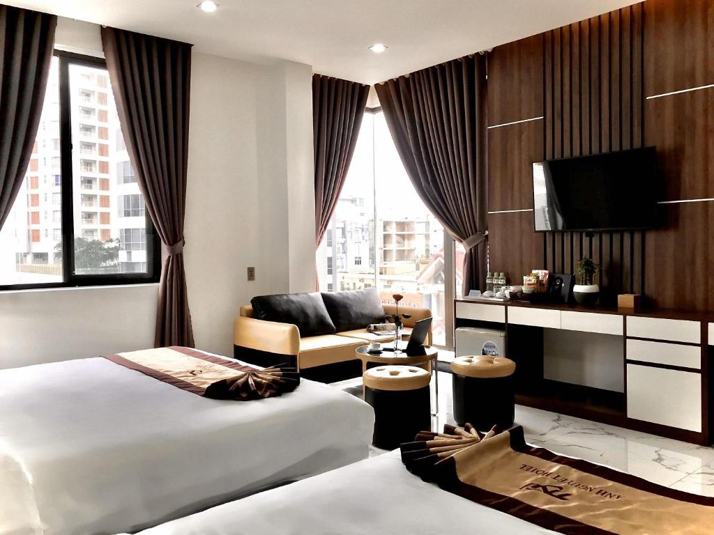 Postel nebo postele na pokoji v ubytování Anh Nguyet Da Nang Hotel