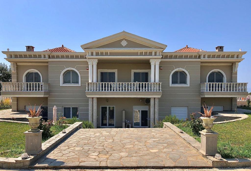 a large house with a driveway in front of it at Villa Dimitri - Penthouse Seaview in Alexandroupoli