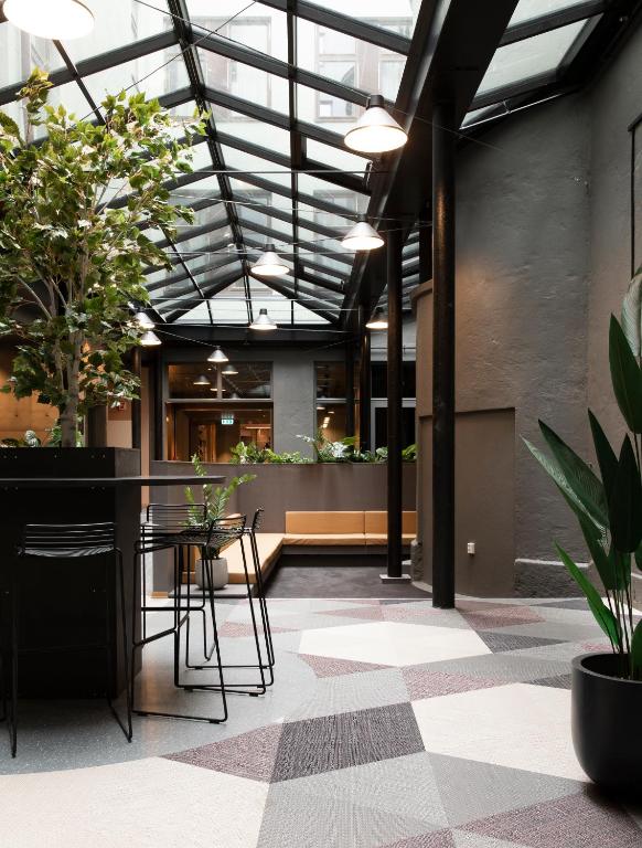 a lobby with a table and chairs and plants at Citybox Oslo in Oslo