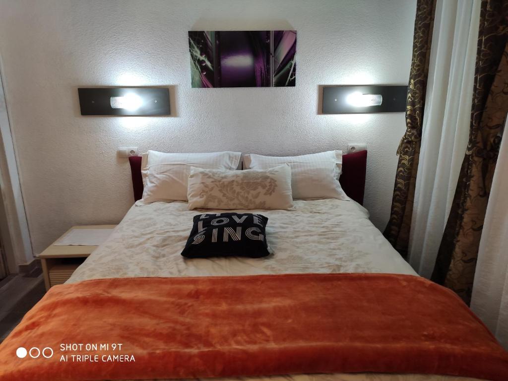 a bedroom with a large bed with a pillow on it at Excellency apartmani in Banja Luka