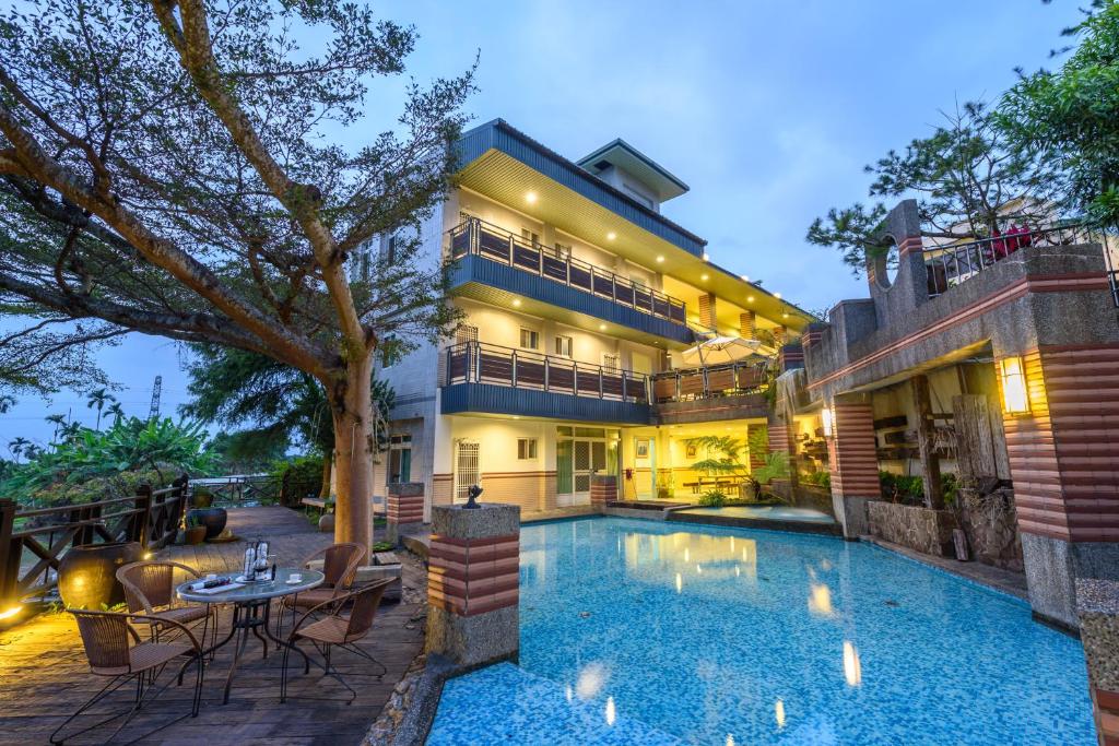 an exterior view of a house with a swimming pool at Yunlin Gukeng Da-Hu Villa B&B in Gukeng