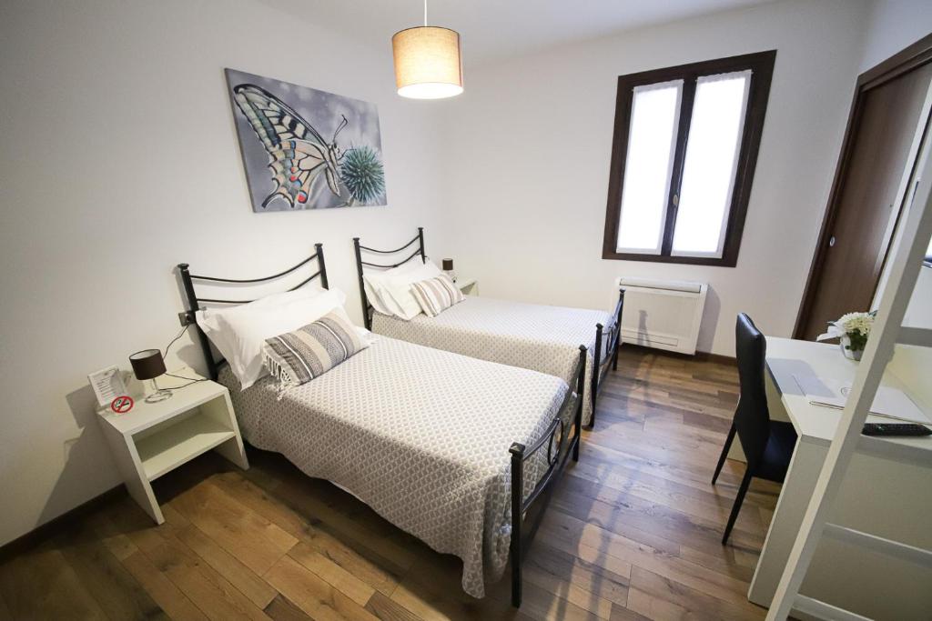 Postel nebo postele na pokoji v ubytování LOCANDA RIGHETTO