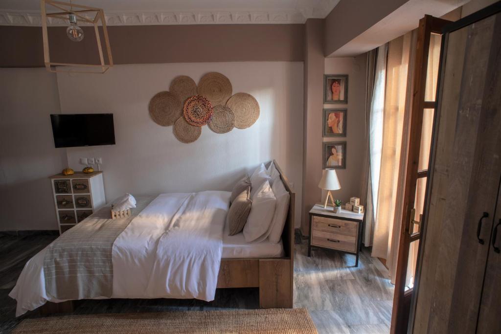 a bedroom with a bed and a television in it at Cozy Studio in Trikala Center with private Parking! in Tríkala