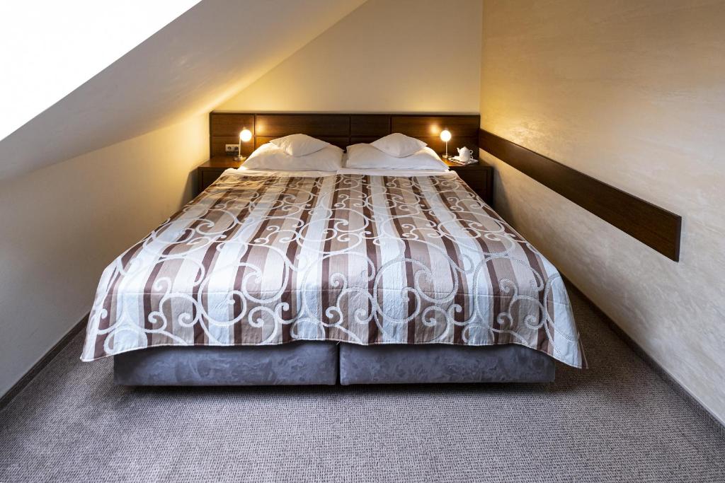 Postel nebo postele na pokoji v ubytování Hotel Mario