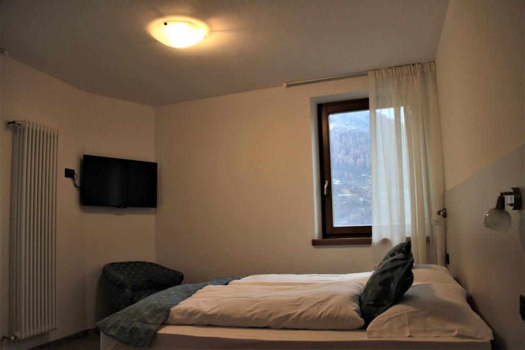 Posteľ alebo postele v izbe v ubytovaní MOUNTAIN RESORT Appartamenti