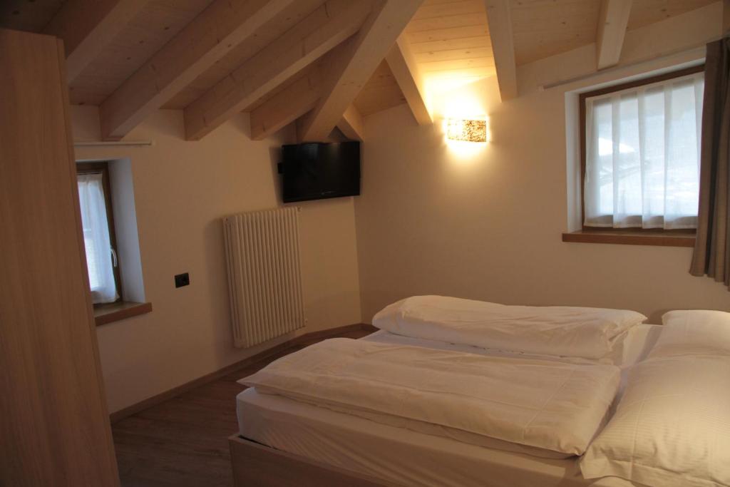 Posteľ alebo postele v izbe v ubytovaní MOUNTAIN RESORT Appartamenti