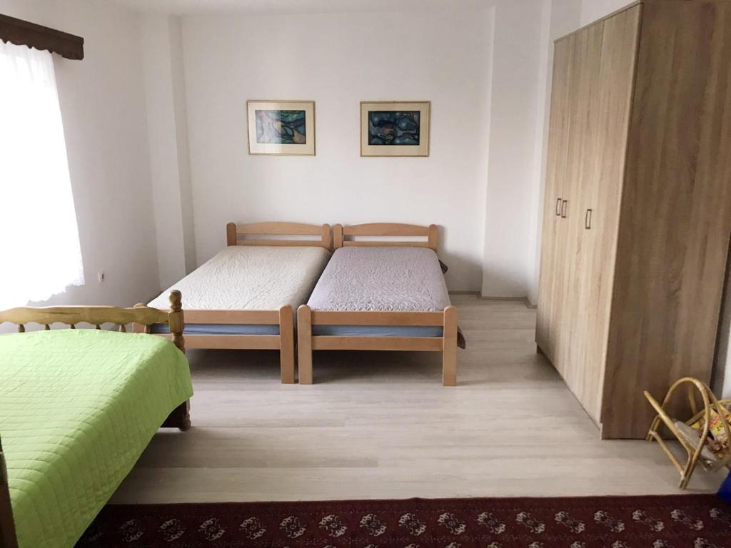 a bedroom with two twin beds and a cabinet at Lydia Center Apartment in Veles