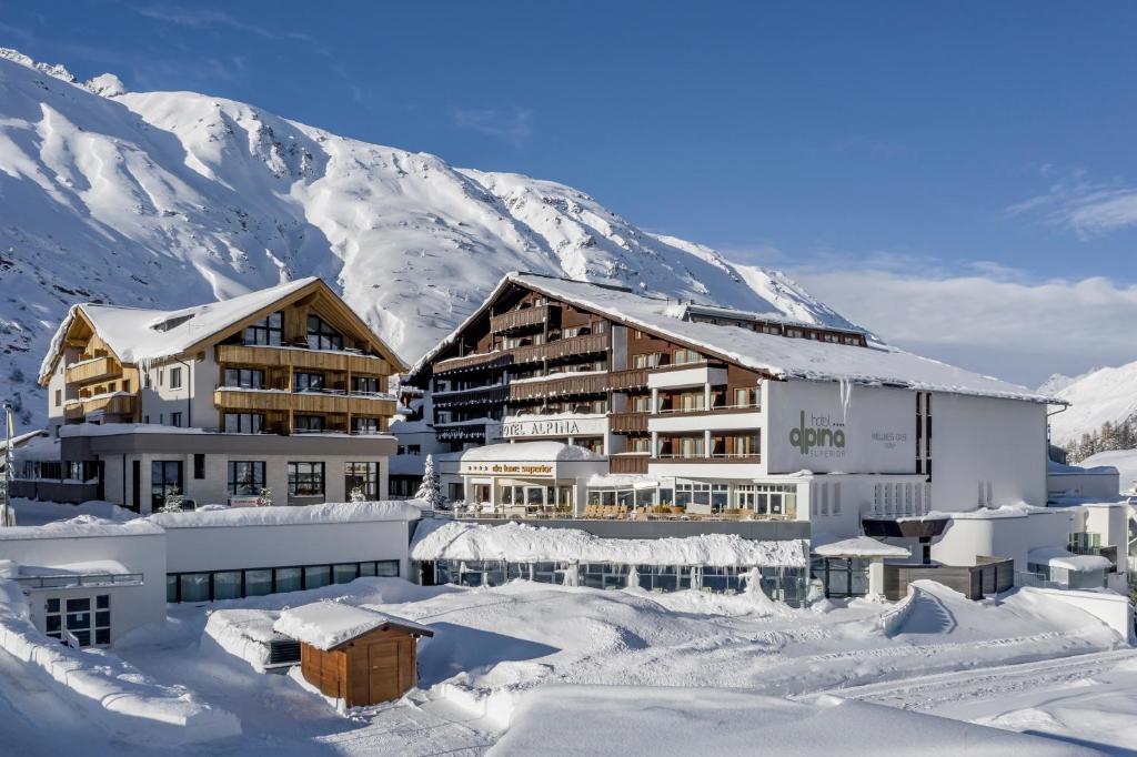 a hotel in the snow in front of a mountain at Hotel Alpina deluxe in Obergurgl