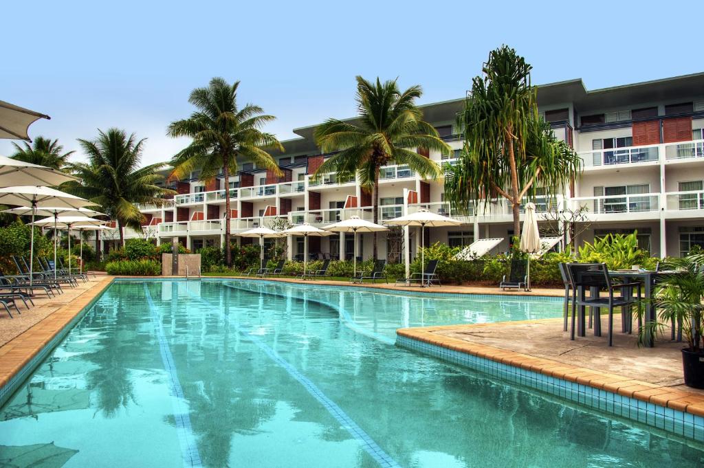 a large swimming pool in front of a hotel at The Terraces Apartments Denarau in Denarau
