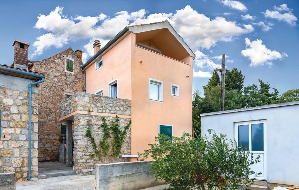 a large brick house with a stone wall at Apartment Miro in Prvić Šepurine