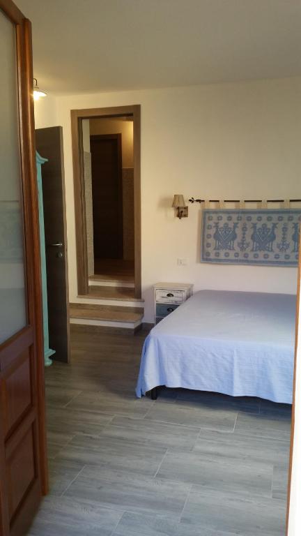 Postel nebo postele na pokoji v ubytování S'apposenteddu Affittacamere del Ristorante da Stefano