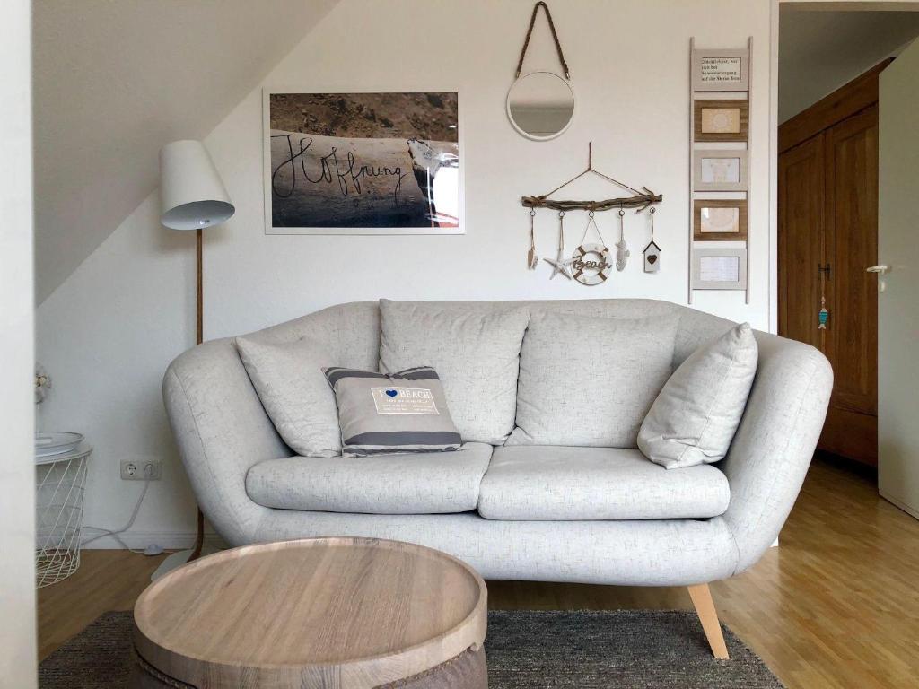 ein Wohnzimmer mit einem Sofa und einem Tisch in der Unterkunft SchoenHier-Timmendorf in Timmendorfer Strand