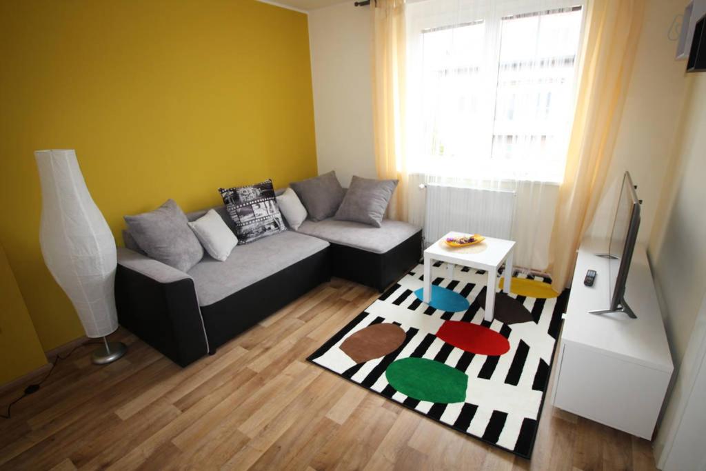 a living room with a couch and a rug at Dreamy Apartment in Prague