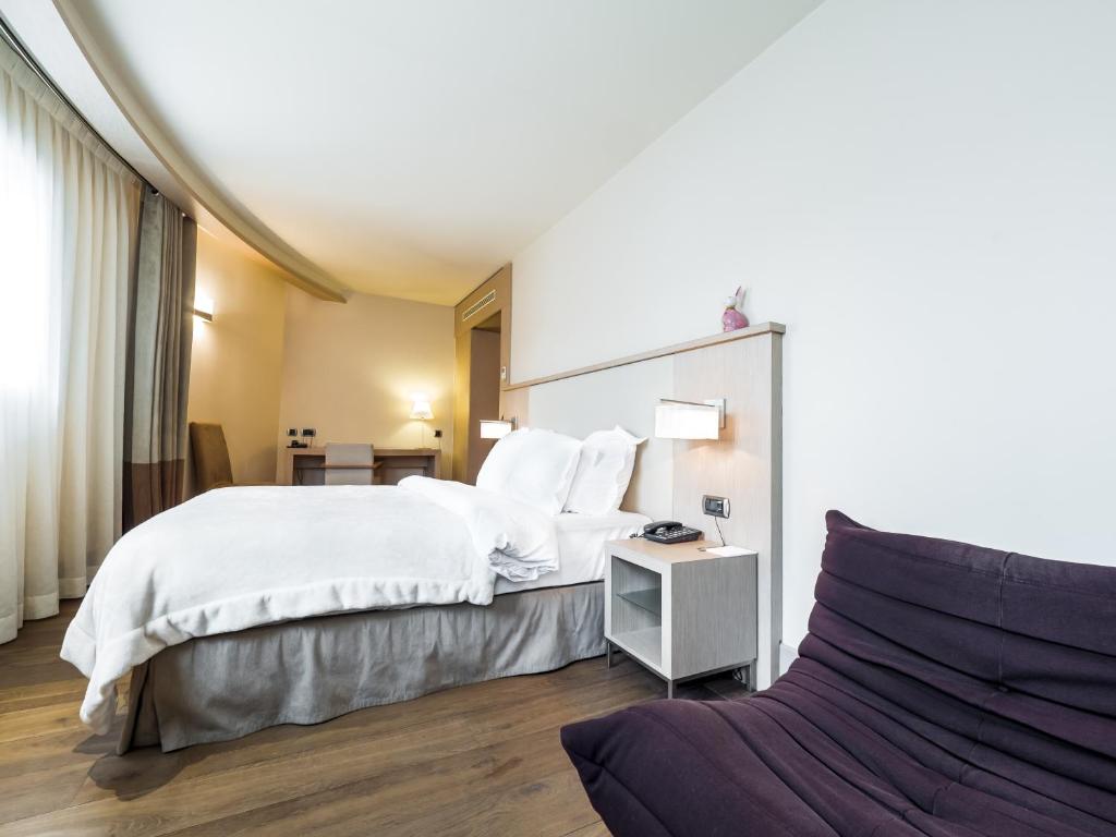 Postel nebo postele na pokoji v ubytování Hôtel Le Pré Carré