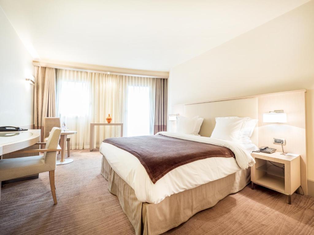 Postel nebo postele na pokoji v ubytování Hôtel Le Pré Carré