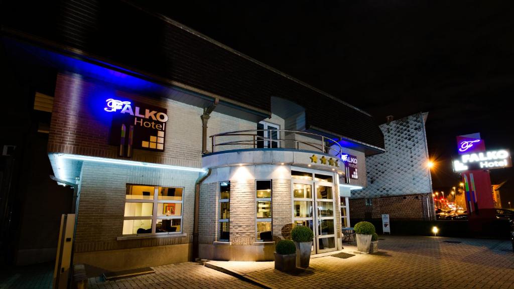 a building with a sign that reads el fuego hotel at Hotel Falko in Meise