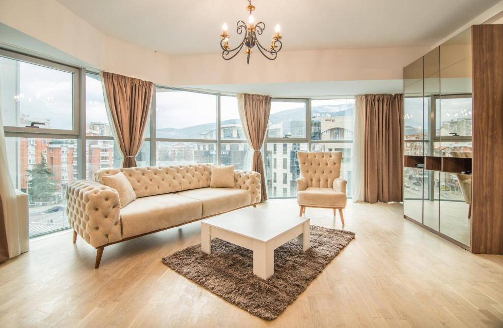 a living room with a couch and a table at The ONE Apart Hotel Luxury Suites & Apartments in Skopje