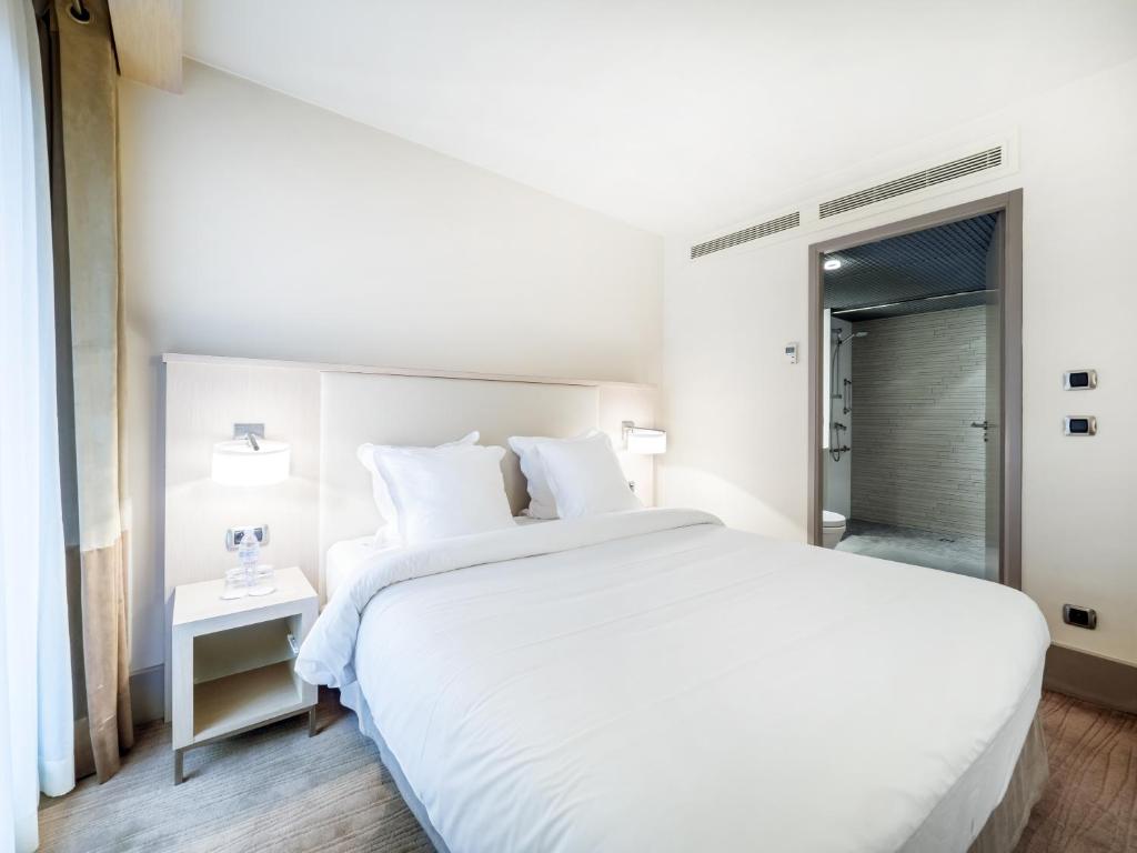 Postel nebo postele na pokoji v ubytování Hôtel Le Pré Carré