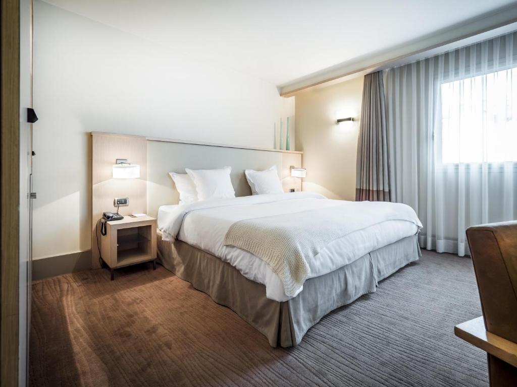 Postel nebo postele na pokoji v ubytování Hôtel Le Pré Carré