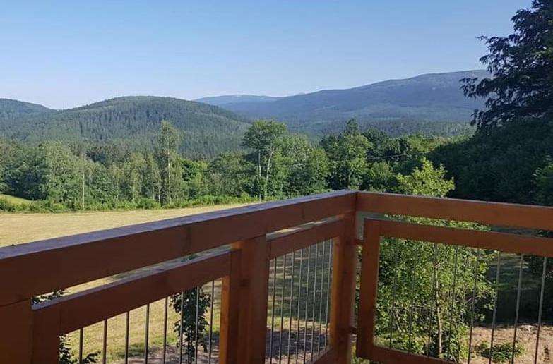 a view of the mountains from the deck of a house at Dream Apart in Szklarska Poręba