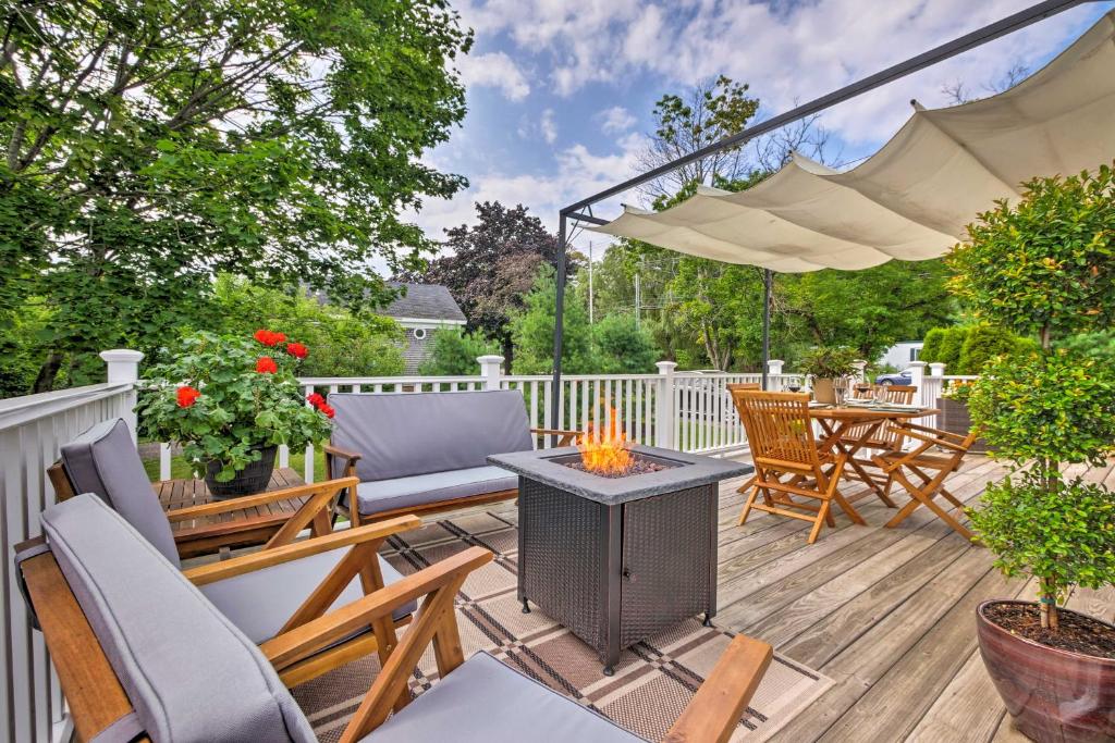 a patio with chairs and a fire pit on a deck at Rockland Home with Deck 5 Mins to Historic Downtown! in Rockland