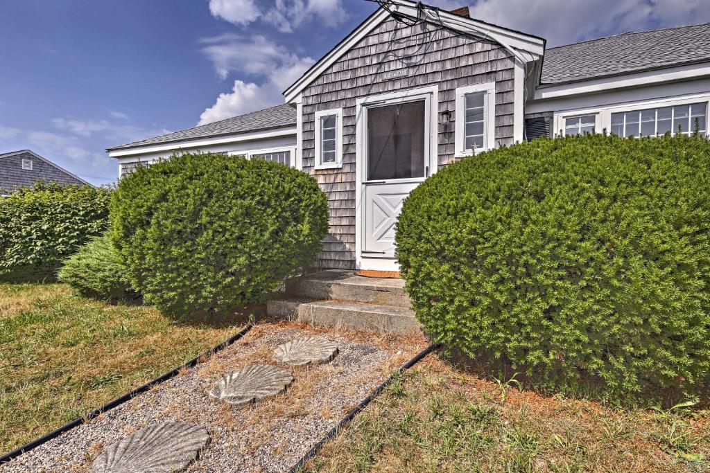 una casa con dos grandes arbustos delante de ella en Updated Cottage - 300 Feet to Craigville Beach!, en Centerville