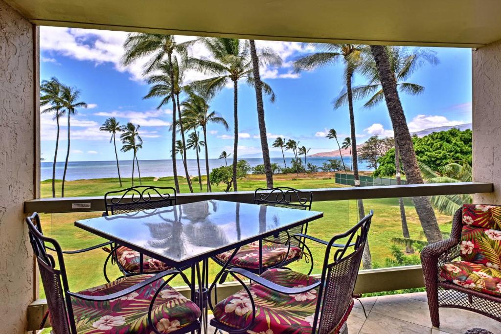 a table and chairs on a balcony with a view of the ocean at Beachside Kihei Vacation Rental with Stunning Views! in Kihei