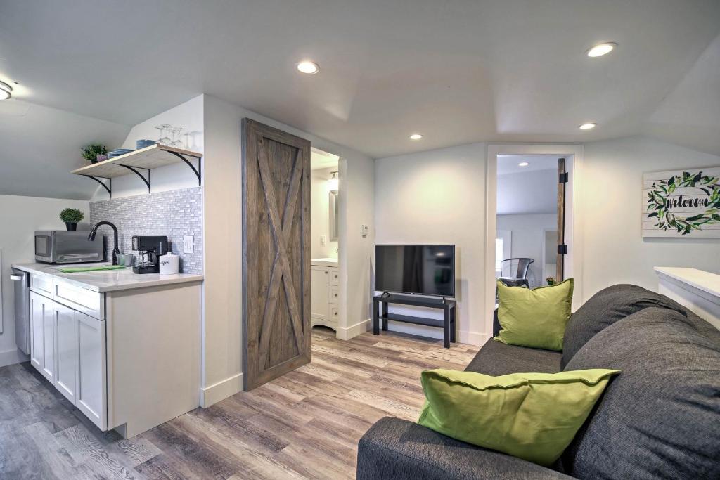 a living room with a couch and a kitchen at Dtwn Golden Apt Less Than 9 Mi to Red Rocks Amphitheater! in Golden