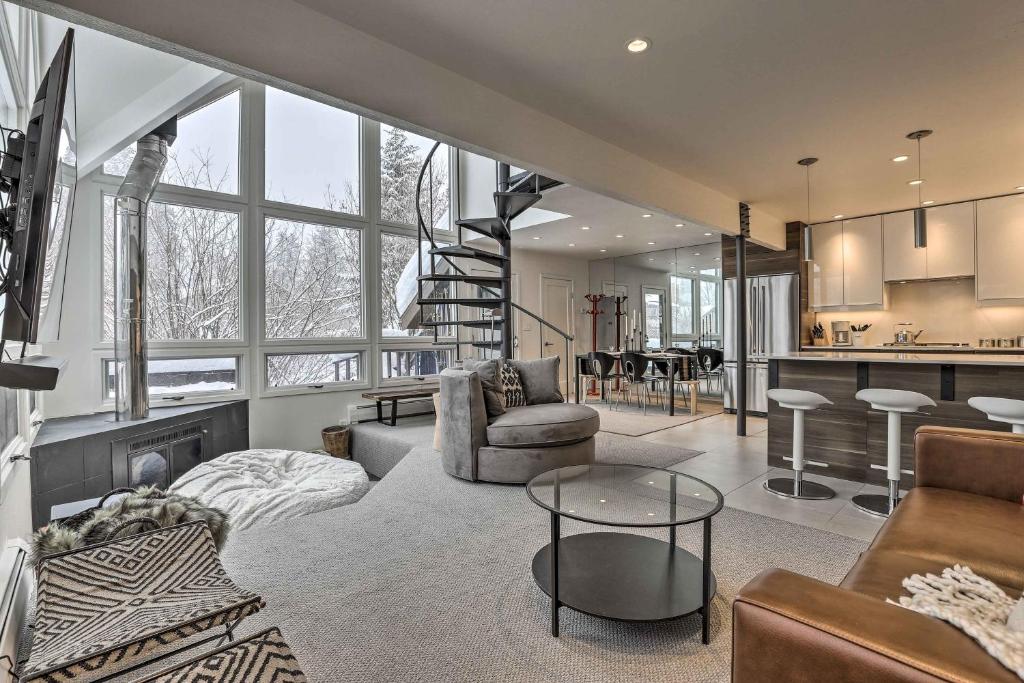 a living room with a couch and a table at Vail Condo with Mtn View Deck - Steps to Ski Shuttle in Vail