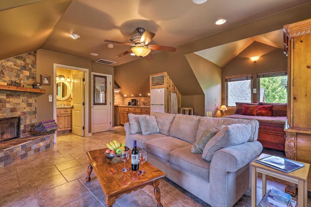 a living room with a couch and a table at Romantic Yosemite and Bass Lake Retreat with Mtn Views! in North Fork