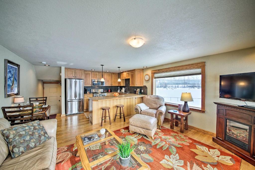 a living room with a couch and a fireplace at Lake Pend Oreille Condo with Porch and Mountain View! in Sandpoint