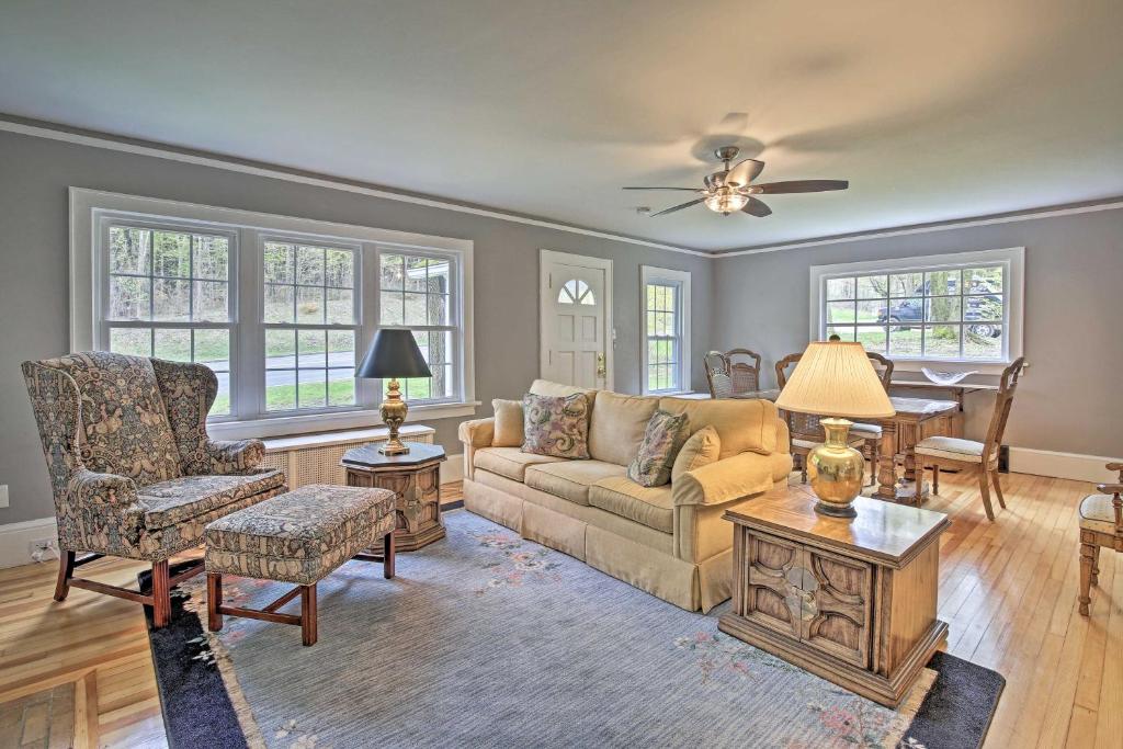 a living room with a couch and a table at Beautiful Lenox Home, 3 Mi to Shakespeare and Co! in Lenox