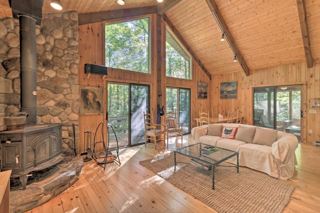 a living room with a couch and a fireplace at Cabin with 3 Acres, Tennis Courts By 4 Ski Mtns in Sandisfield