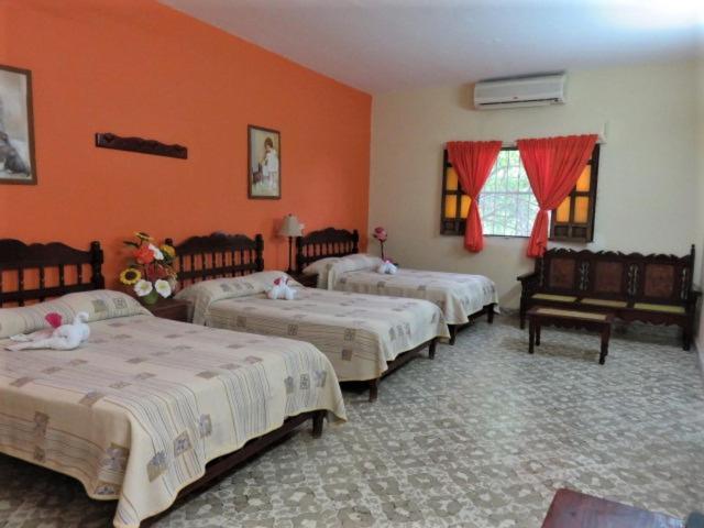 A bed or beds in a room at Hotel D´ Carmona