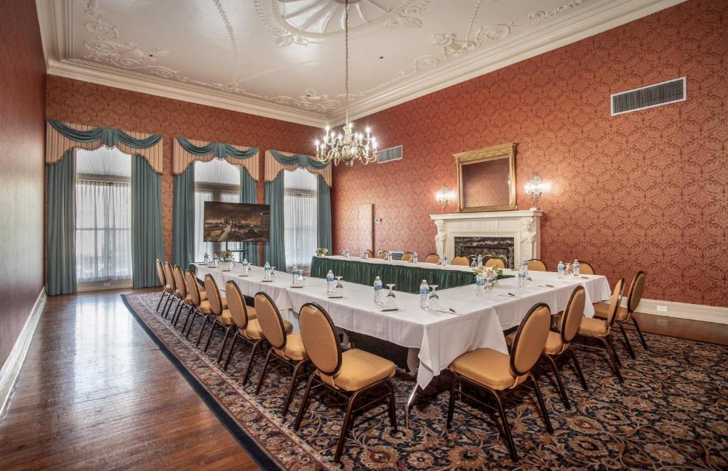 a large banquet room with a long table and chairs at Menger Hotel in San Antonio