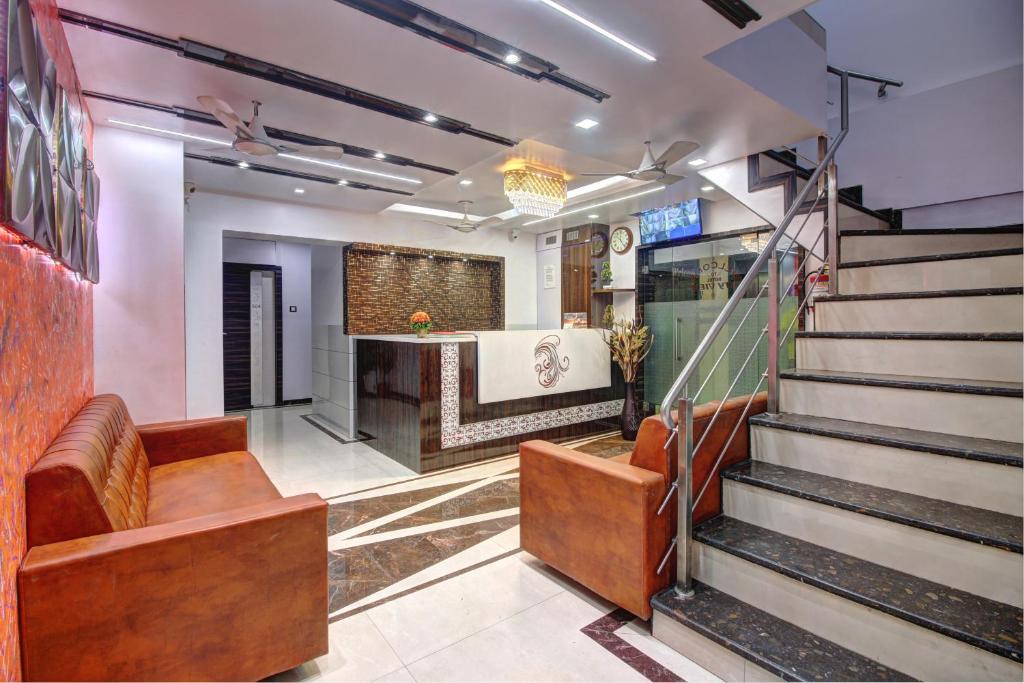 a lobby of a restaurant with stairs and a bar at Hotel City View in Navi Mumbai