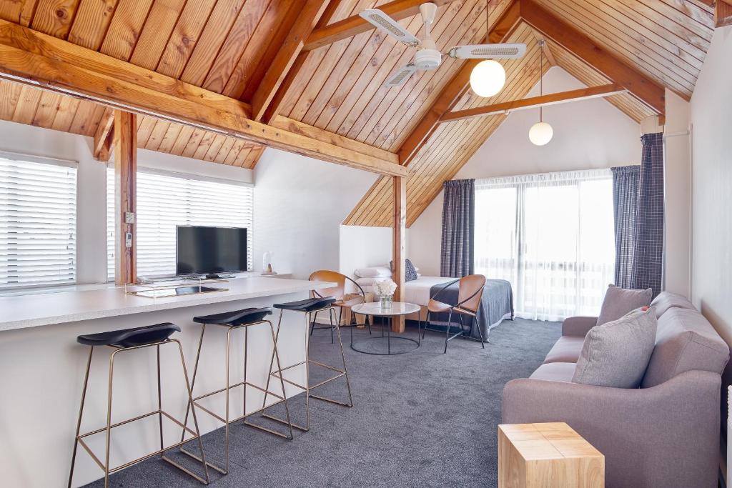 a living room with a couch and a table at Hotel Carlton Mill in Christchurch