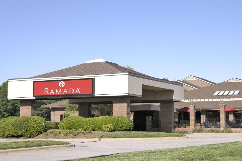 a building with a sign that reads ramada at Ramada by Wyndham Raleigh in Raleigh