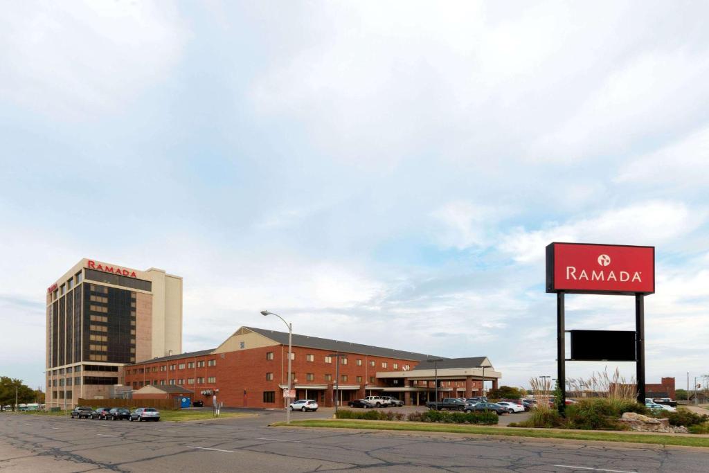 a red brick building with a sign on the side of it at Ramada by Wyndham Topeka Downtown Hotel & Convention Center in Topeka