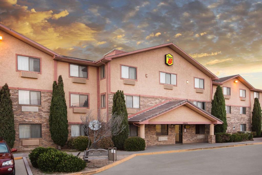 a hotel with a sign on the front of it at Super 8 by Wyndham Kingman in Kingman