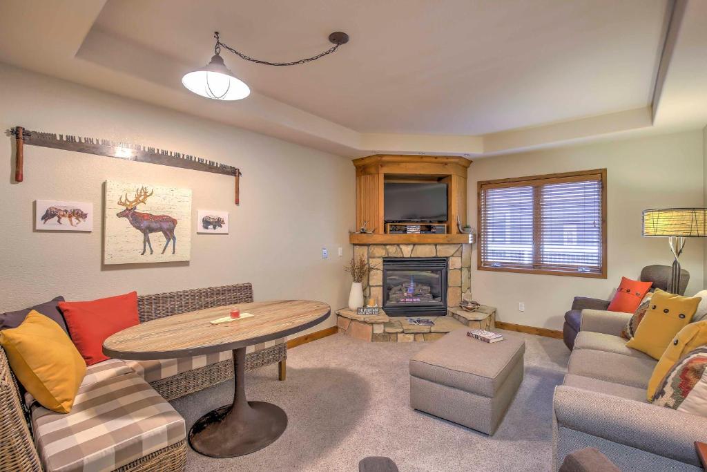 a living room with a couch and a table at Walk to Ski Slopes and Main St Cozy Breck Condo! in Breckenridge
