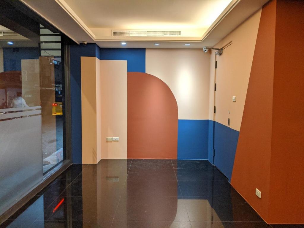 an empty hallway with blue and orange walls at Guide Hotel Taipei Xinyi in Taipei