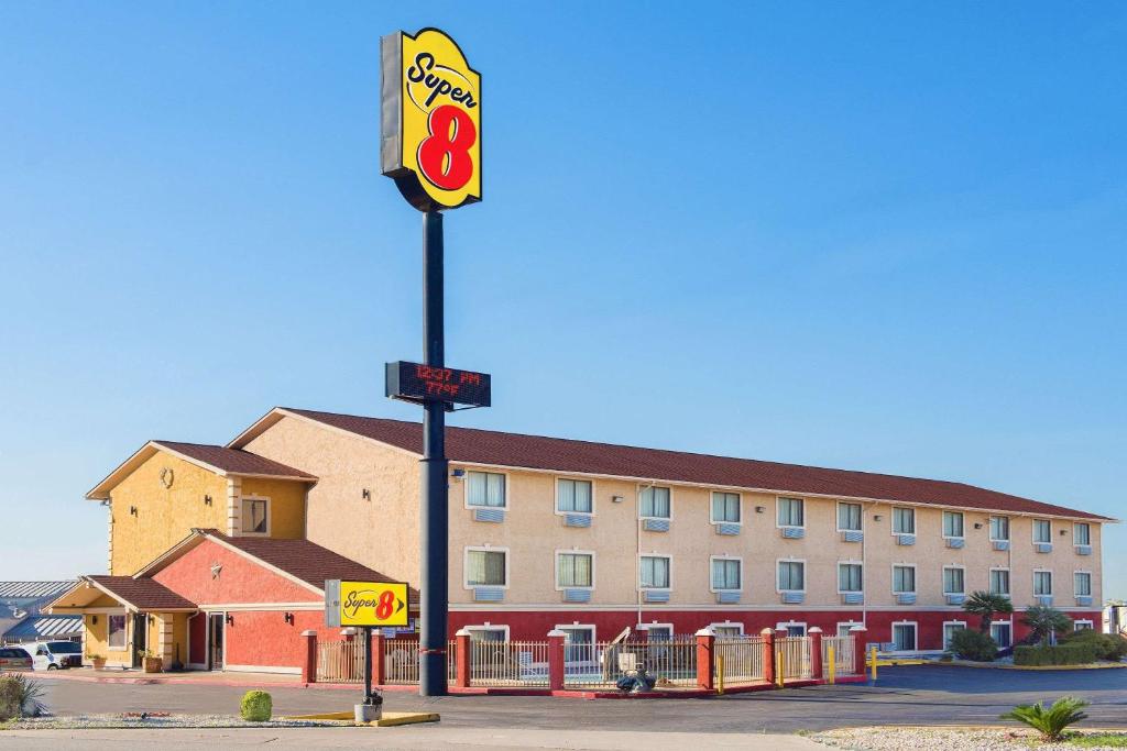 a hotel with a sign in front of a building at Super 8 by Wyndham San Antonio/I-35 North in San Antonio