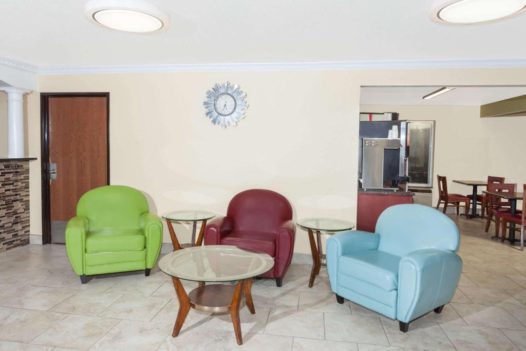 a waiting room with three chairs and a table at Days Inn by Wyndham Springfield in Springfield