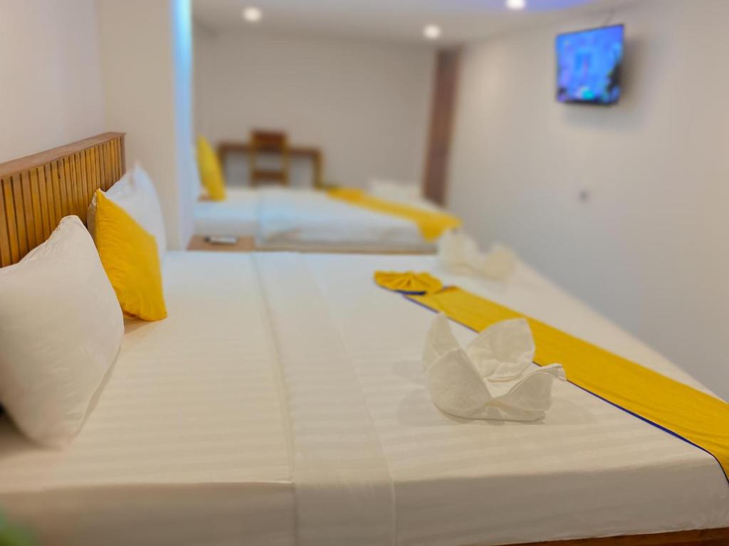 Postel nebo postele na pokoji v ubytování Grand Elevation Hotel