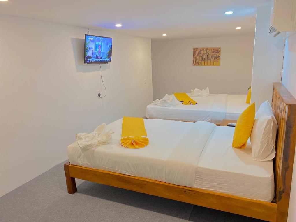 Postel nebo postele na pokoji v ubytování Grand Elevation Hotel